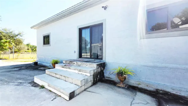 a spacious bedroom with a bed table and a couch