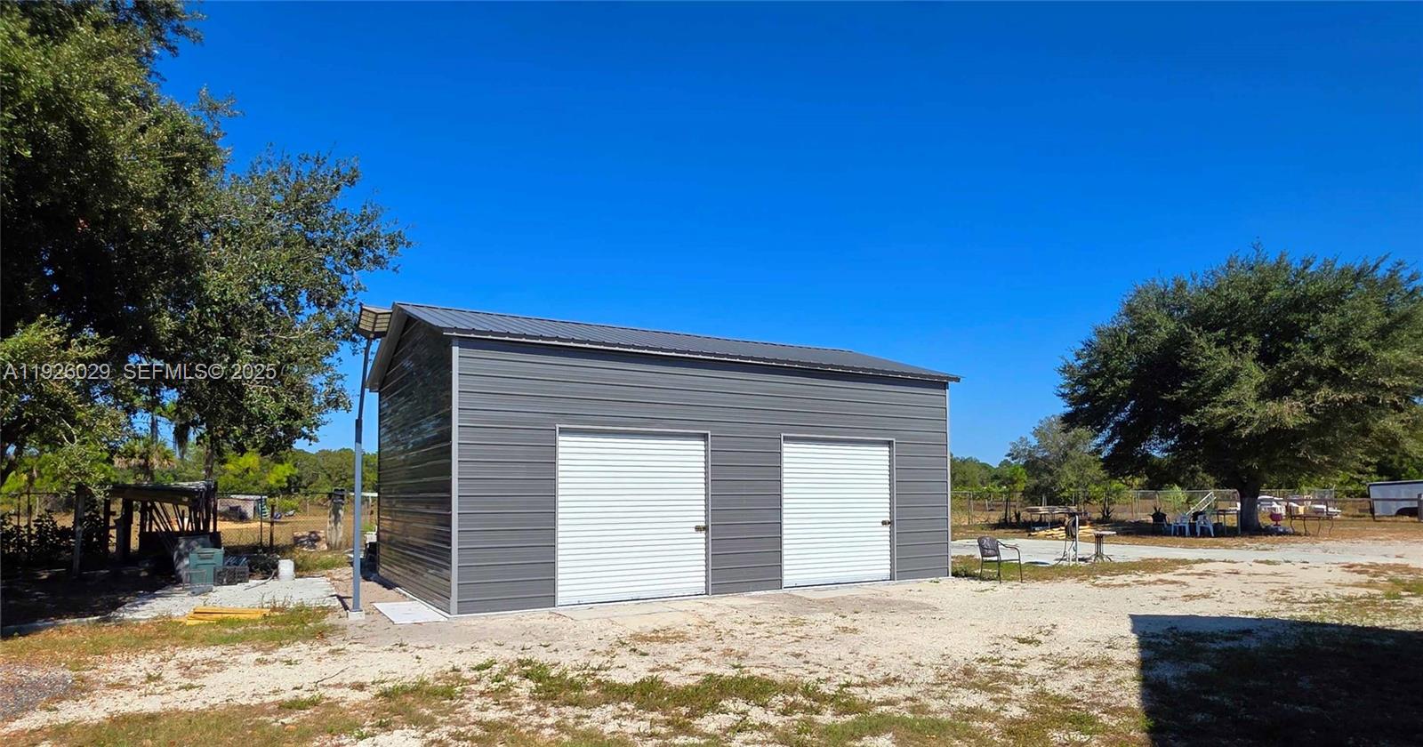 527 Perimeter Road Clewiston, FL 33440 - Photo 22 of 40 a view of a house with a yard covered with snow in the background