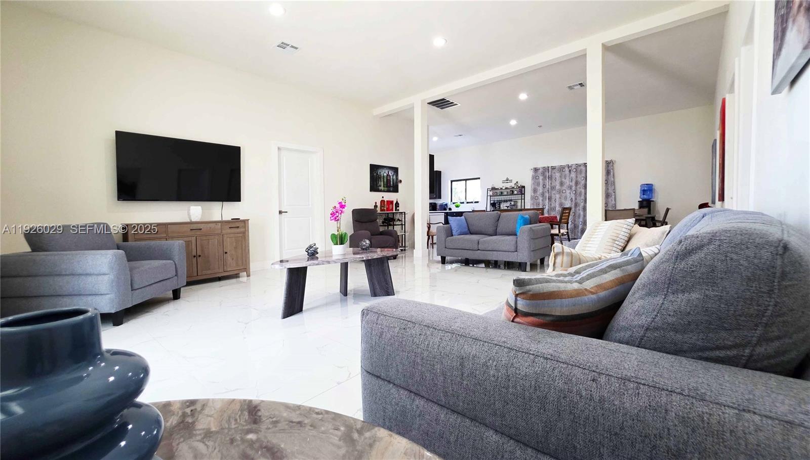 527 Perimeter Road Clewiston, FL 33440 - Photo 6 of 40 a living room with furniture and a flat screen tv