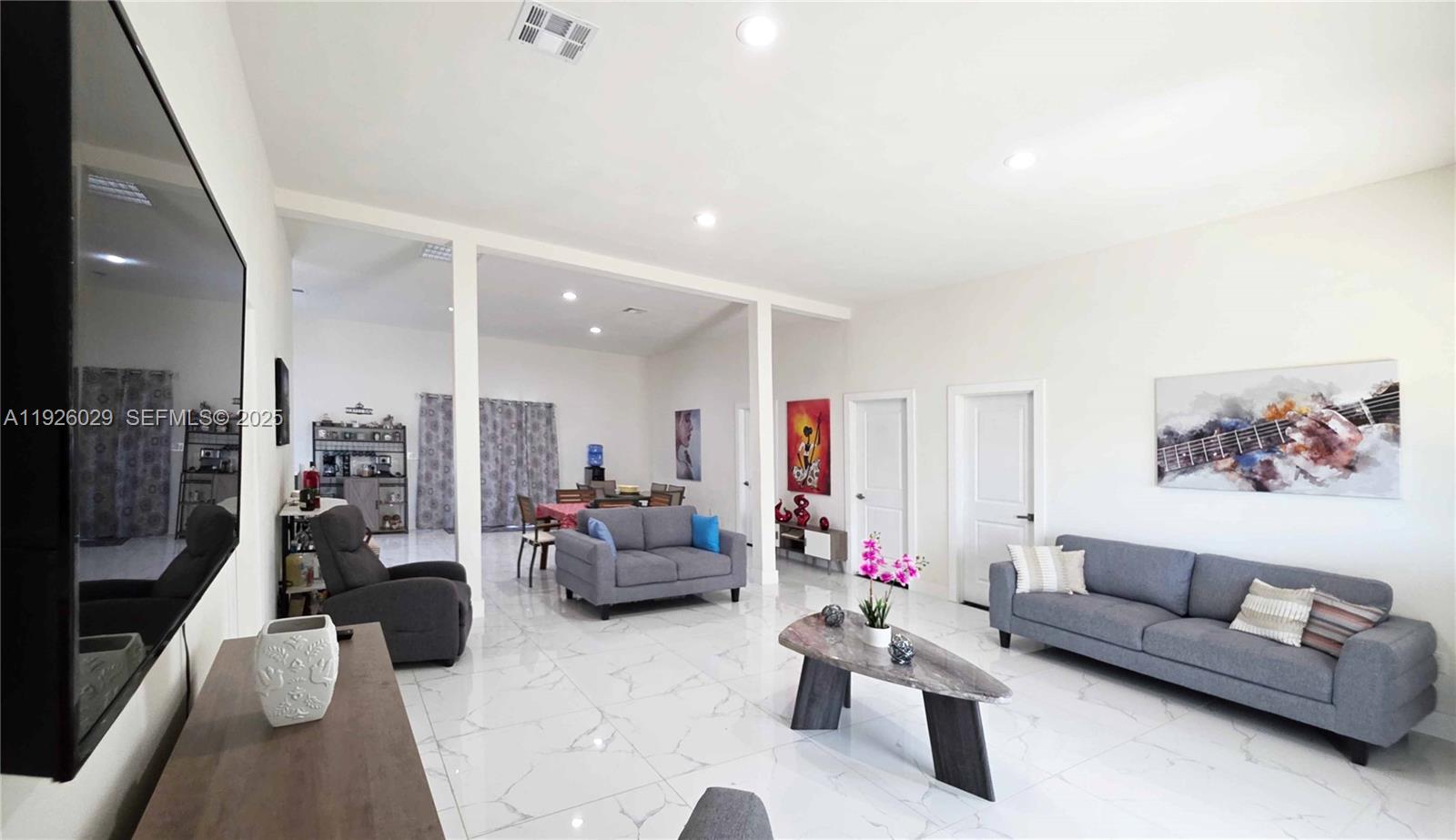 527 Perimeter Road Clewiston, FL 33440 - Photo 7 of 40 a living room with furniture and a flat screen tv