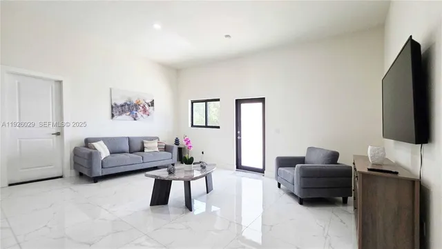 a living room with furniture and a flat screen tv