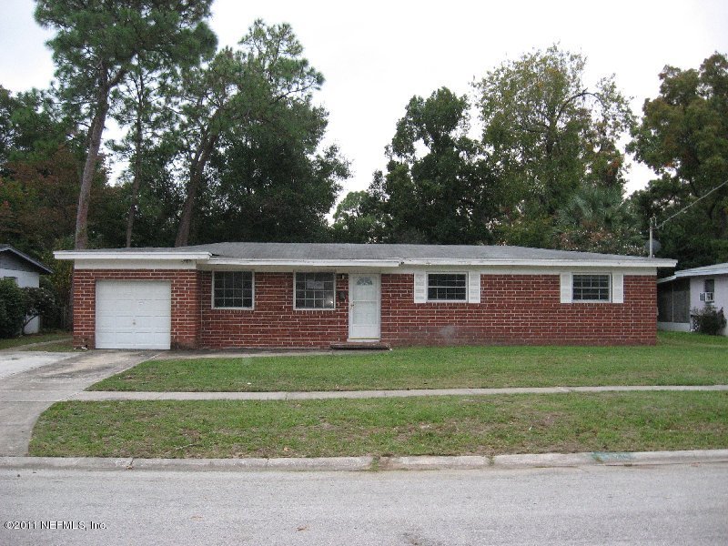 6732 Heidi Road Jacksonville, FL 32277 - Photo 1 of 10 a front view of a house with a garden and trees