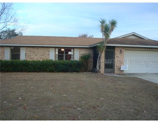 1703 Dublin Road Deltona, FL 32738 - Photo 1 of 1 a front view of a house with a yard and garage