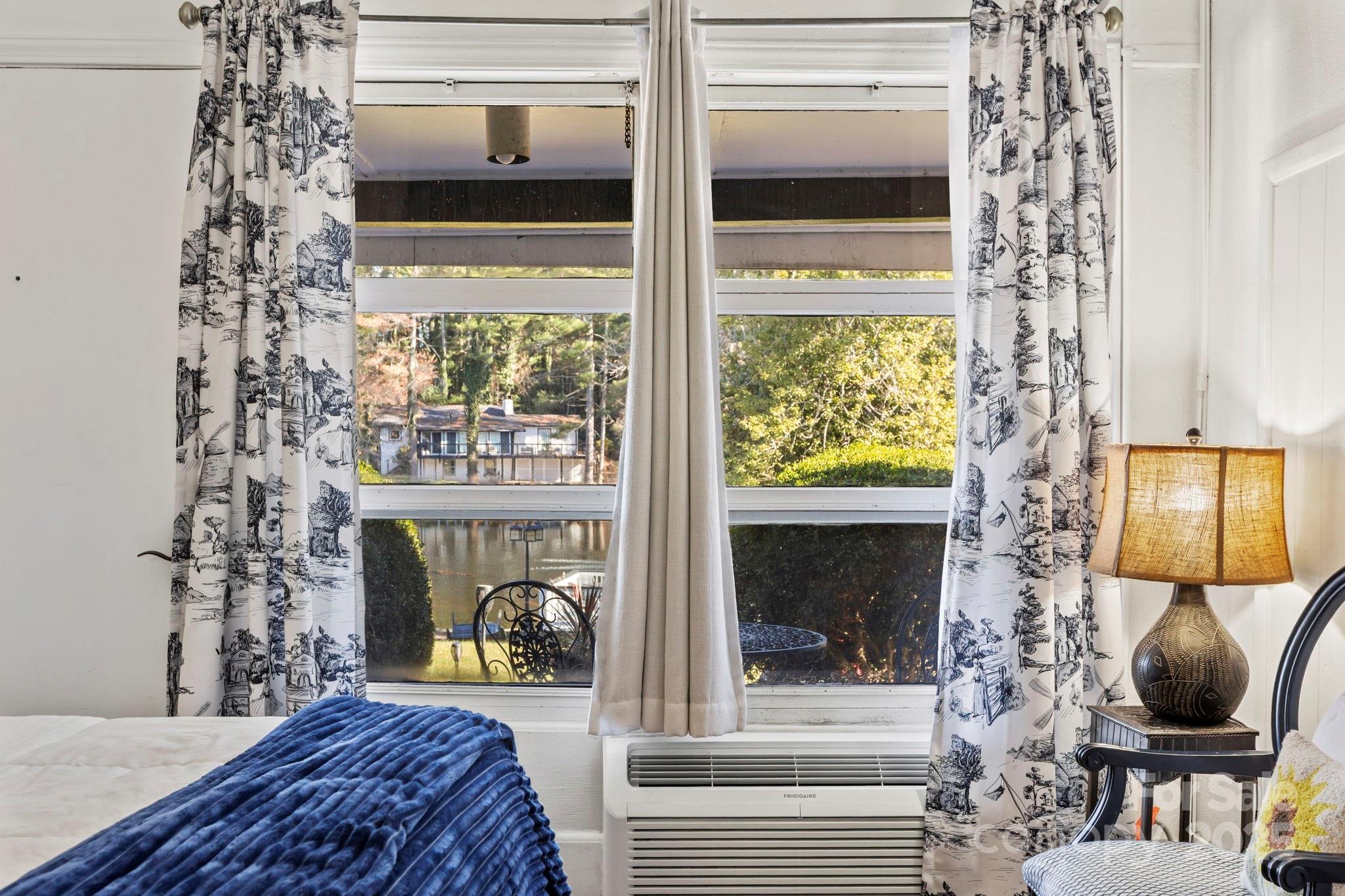 130 Old Mill Road, Unit 202 Flat Rock, NC 28731 - Photo 12 of 25 a bedroom with a bed and a window