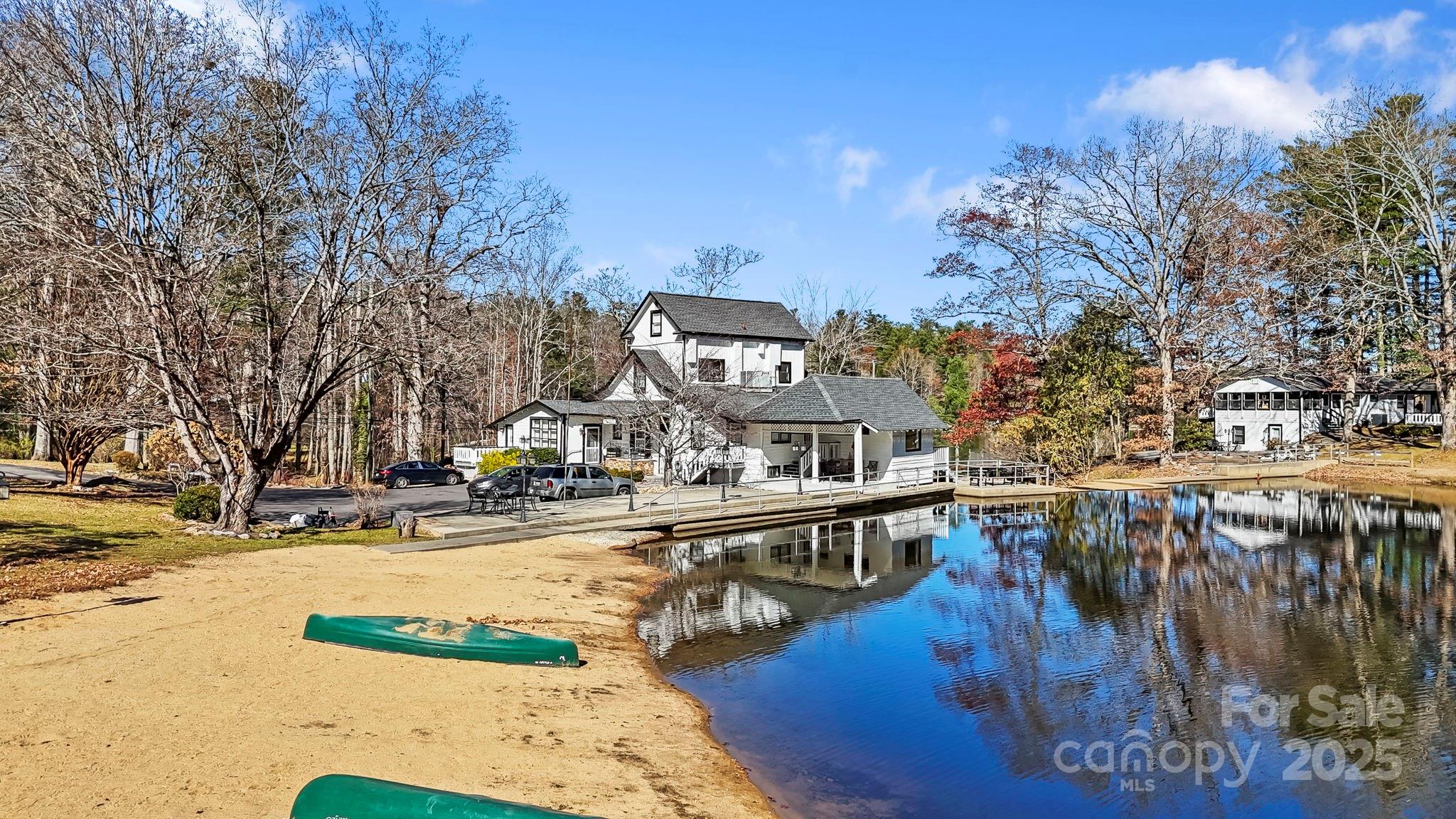 130 Old Mill Road, Unit 202 Flat Rock, NC 28731 - Photo 15 of 25 a view of a lake with a building in the background