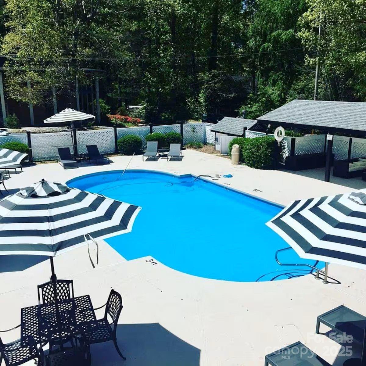 130 Old Mill Road, Unit 202 Flat Rock, NC 28731 - Photo 16 of 25 a view of a patio with table and chairs potted plants with wooden floor