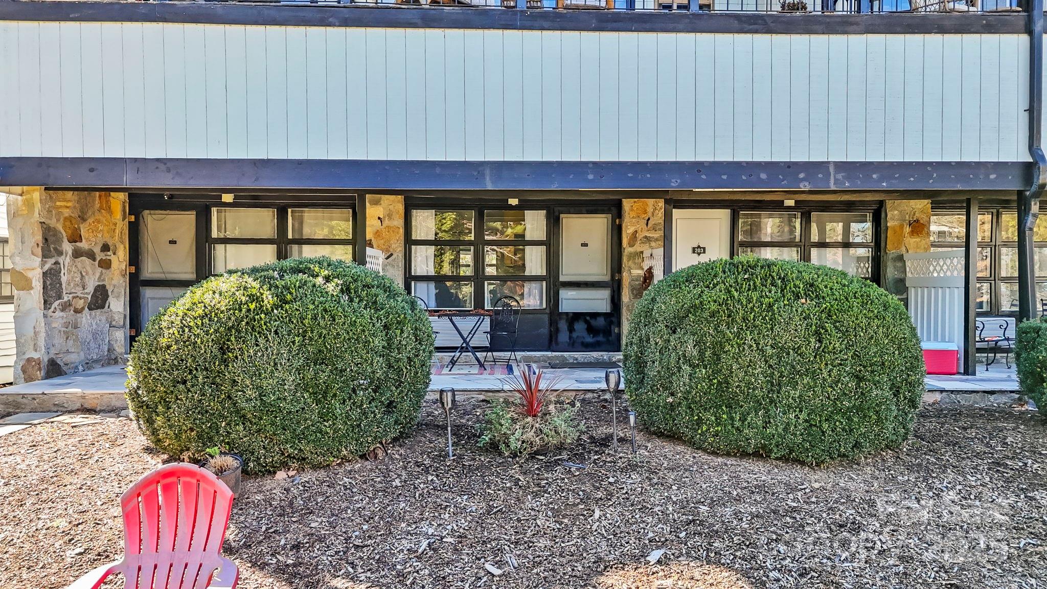130 Old Mill Road, Unit 202 Flat Rock, NC 28731 - Photo 20 of 25 a view of a large window with table and chairs in front of it