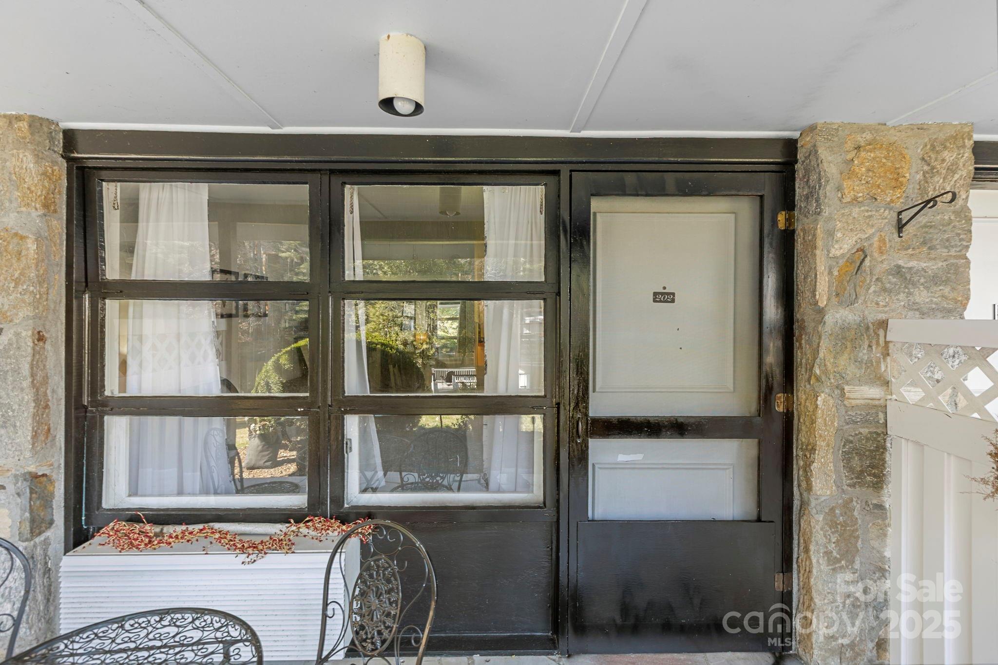 130 Old Mill Road, Unit 202 Flat Rock, NC 28731 - Photo 21 of 25 a living room with furniture and a window