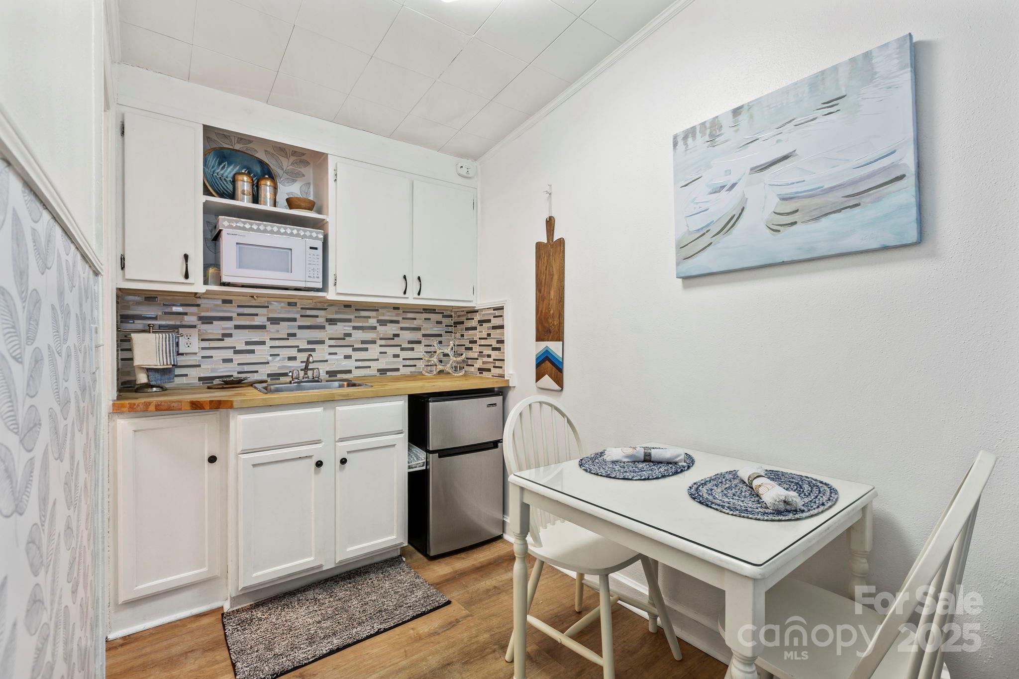 130 Old Mill Road, Unit 202 Flat Rock, NC 28731 - Photo 4 of 25 a kitchen with a stove and cabinets