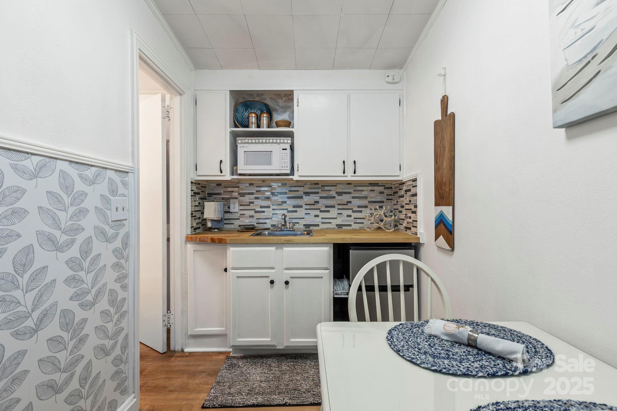 130 Old Mill Road, Unit 202 Flat Rock, NC 28731 - Photo 5 of 25 a view of cabinets with wooden floor