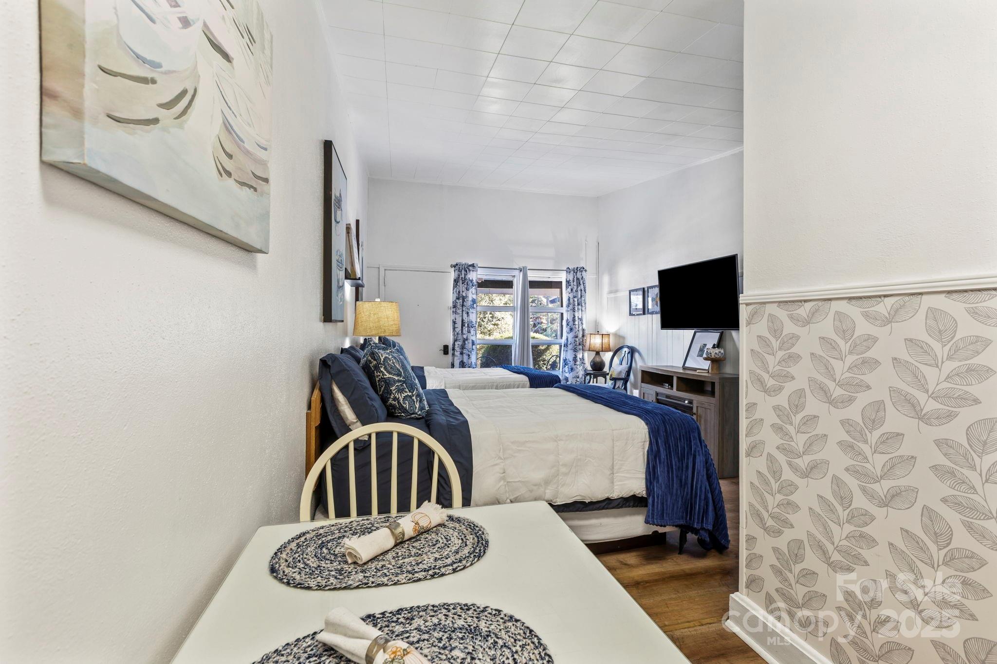 130 Old Mill Road, Unit 202 Flat Rock, NC 28731 - Photo 7 of 25 a bedroom with a bed and a flat screen tv