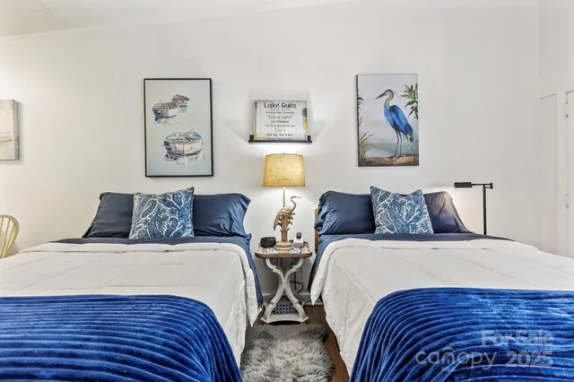 a bedroom with two beds and painting on the wall