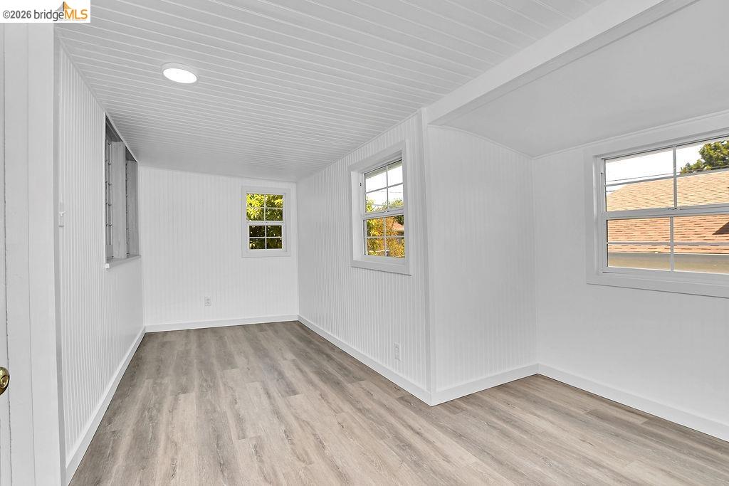 325 South 2nd Street Rio Vista, CA 94571 - Photo 17 of 33 Interior room featuring wood-finish flooring, white beadboard paneling, recessed lighting, and multiple windows with grilles