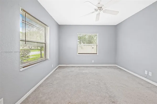 an empty room with windows and closet