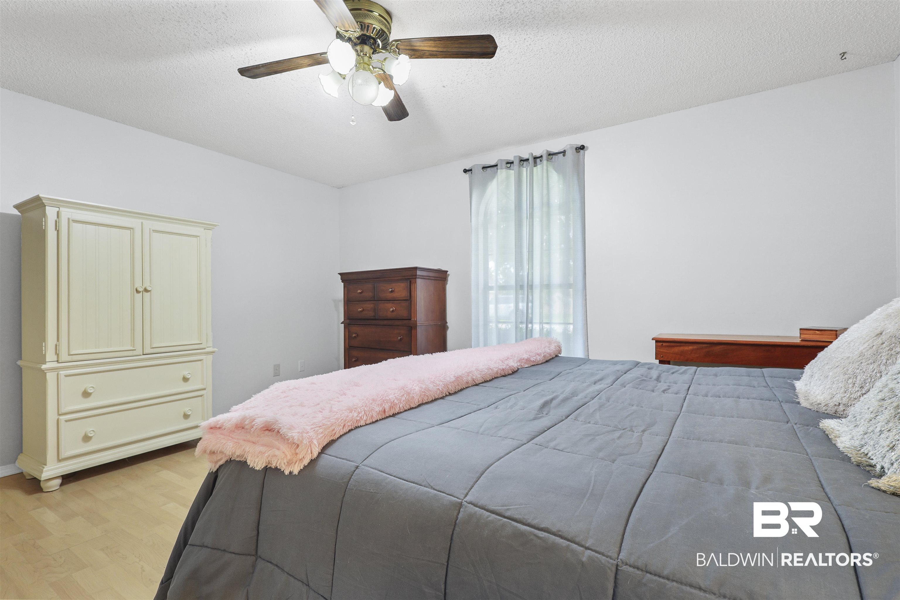 507 West Amanda Avenue Foley, AL 36535 - Photo 8 of 23 Bedroom featuring light hardwood / wood-style floors, ceiling fan, and a textured ceiling