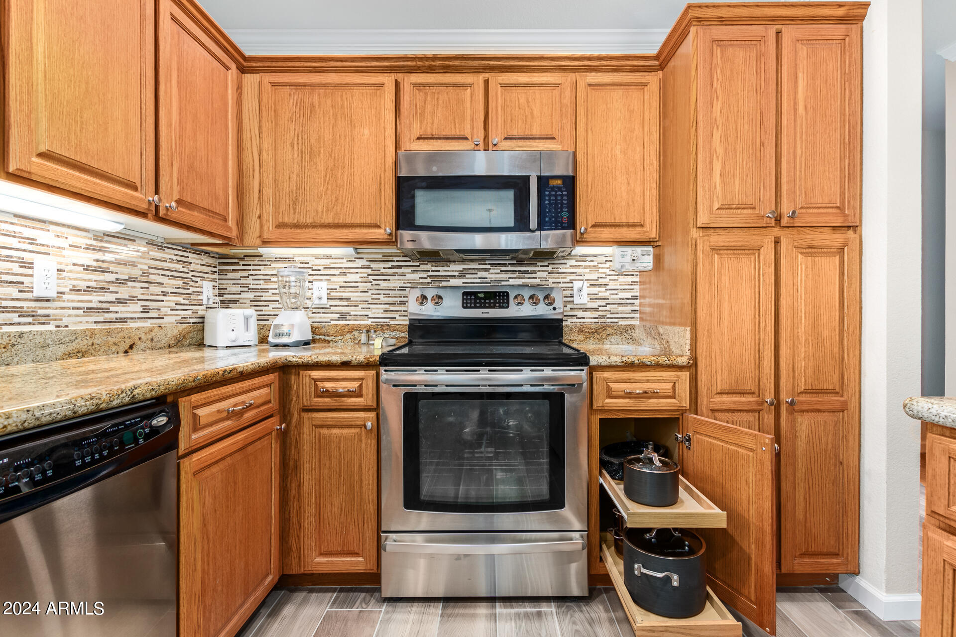 5131 Casper Road Mesa, AZ 85205 - Photo 12 of 32 a kitchen with granite countertop a stove and a sink