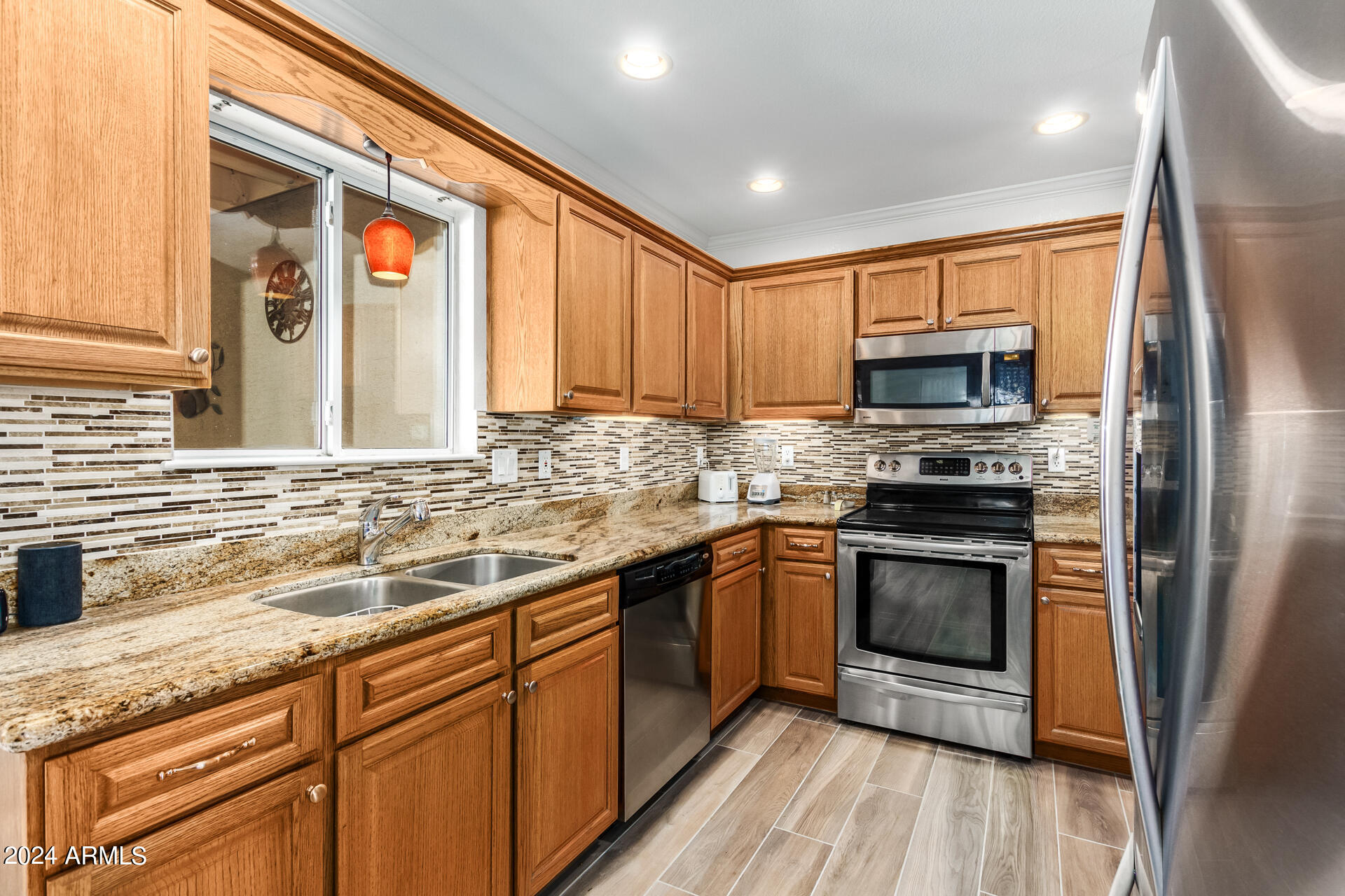 5131 Casper Road Mesa, AZ 85205 - Photo 13 of 32 a kitchen with stainless steel appliances granite countertop a stove a sink and a microwave
