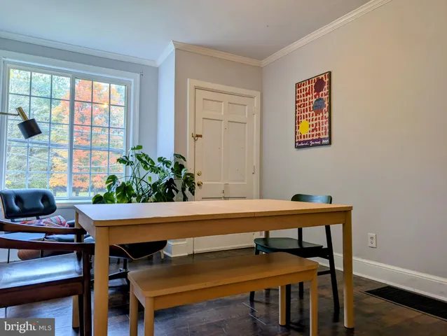 a view of a dining room with furniture and a potted plant