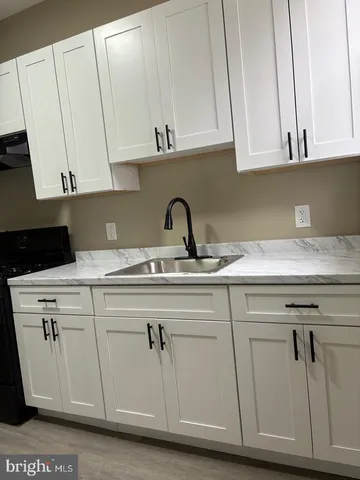 a kitchen with appliances cabinets and a sink