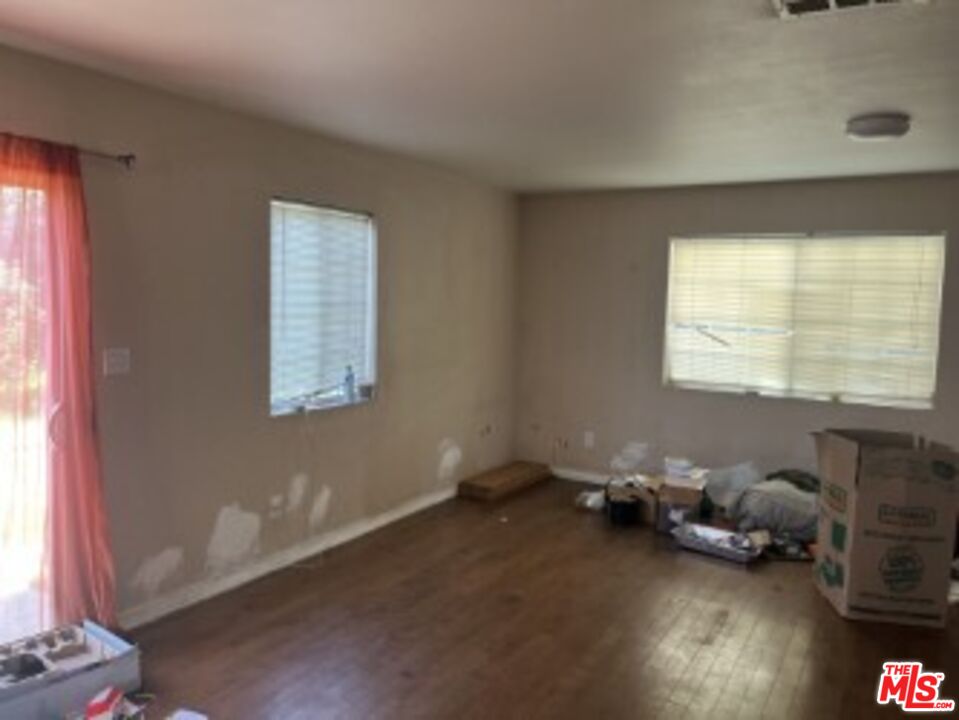 2223 East Oris Street Compton, CA 90222 - Photo 6 of 17 a room with furniture and a window