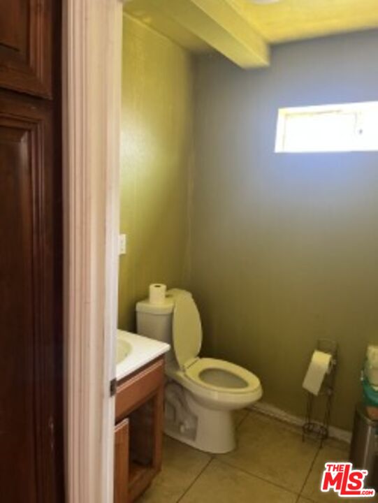 2223 East Oris Street Compton, CA 90222 - Photo 7 of 17 a white toilet sitting next to a bathroom sink