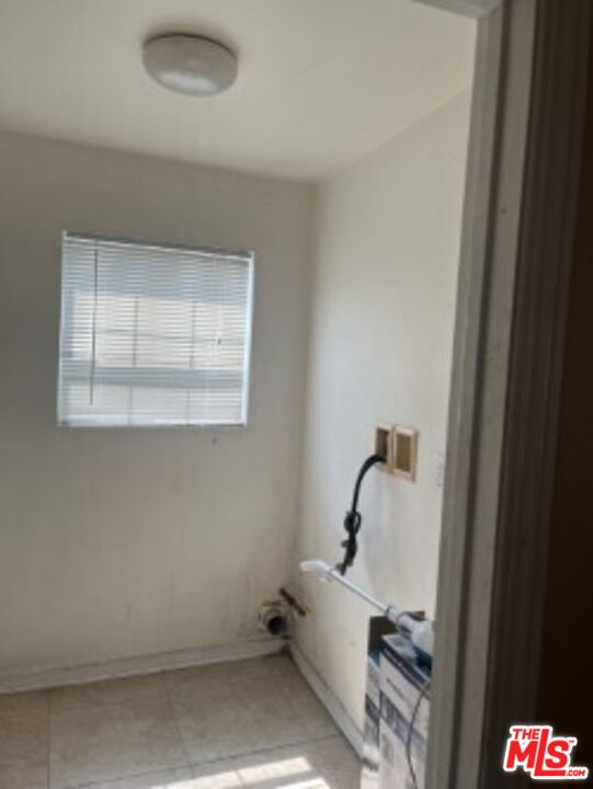 2223 East Oris Street Compton, CA 90222 - Photo 8 of 17 a bathroom with a bathtub and a window