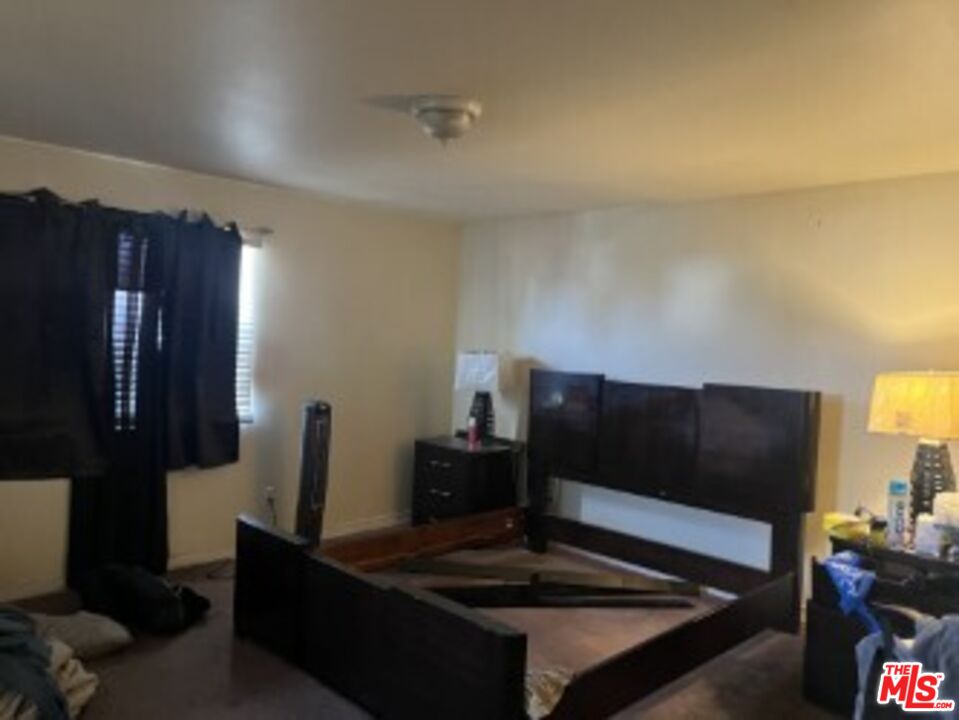 2223 East Oris Street Compton, CA 90222 - Photo 9 of 17 a living room with furniture and a lamp