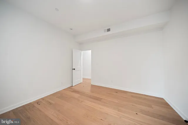 a spacious bedroom with a bed and a couch