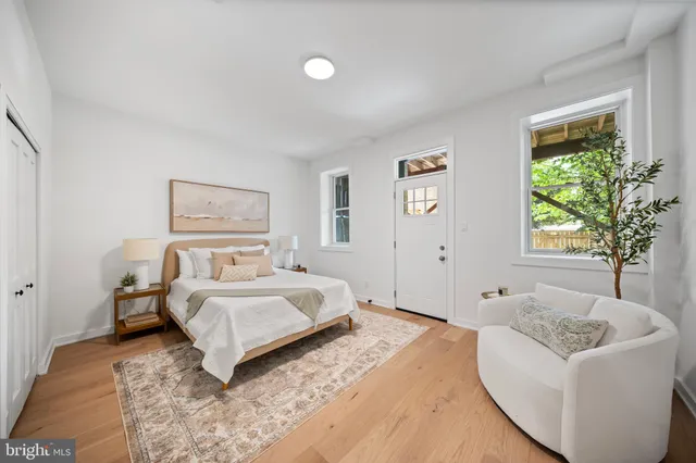 a bedroom with a bed and a painting on the wall