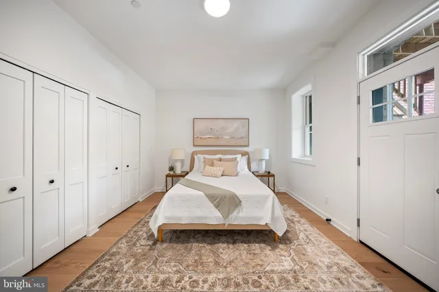 a bedroom with a bed and a painting on the wall
