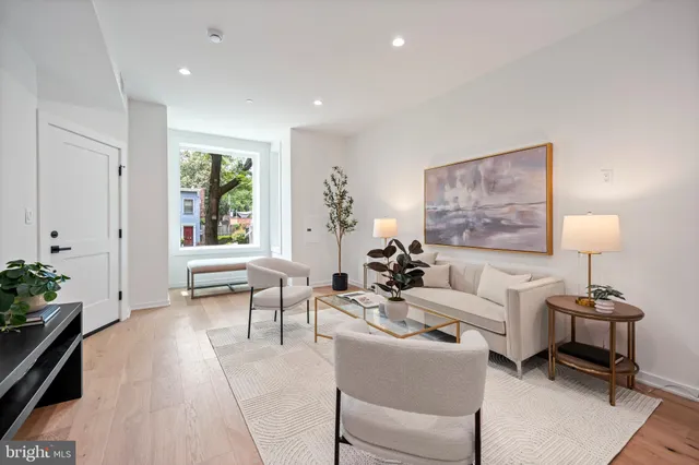 a living room with furniture and a lamp