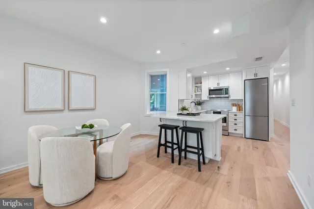 a kitchen with a sink cabinets and wooden floor