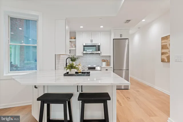 a kitchen with stainless steel appliances a sink stove and refrigerator