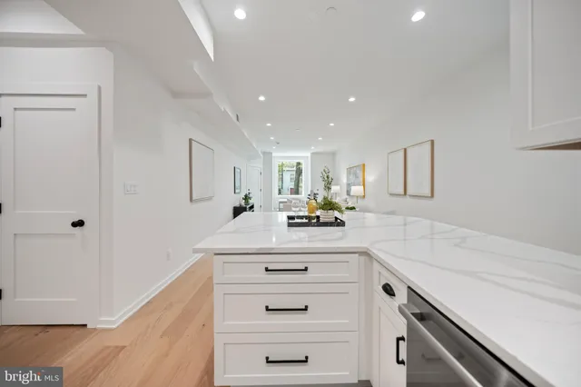 a large white kitchen with a washer and dryer