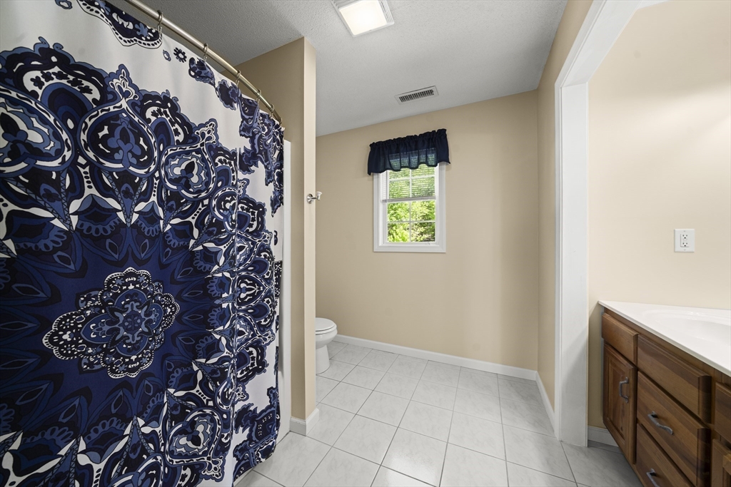 1507 East Mountain Road Westfield, MA 01085 - Photo 20 of 42 a bathroom with a toilet and a shower curtain