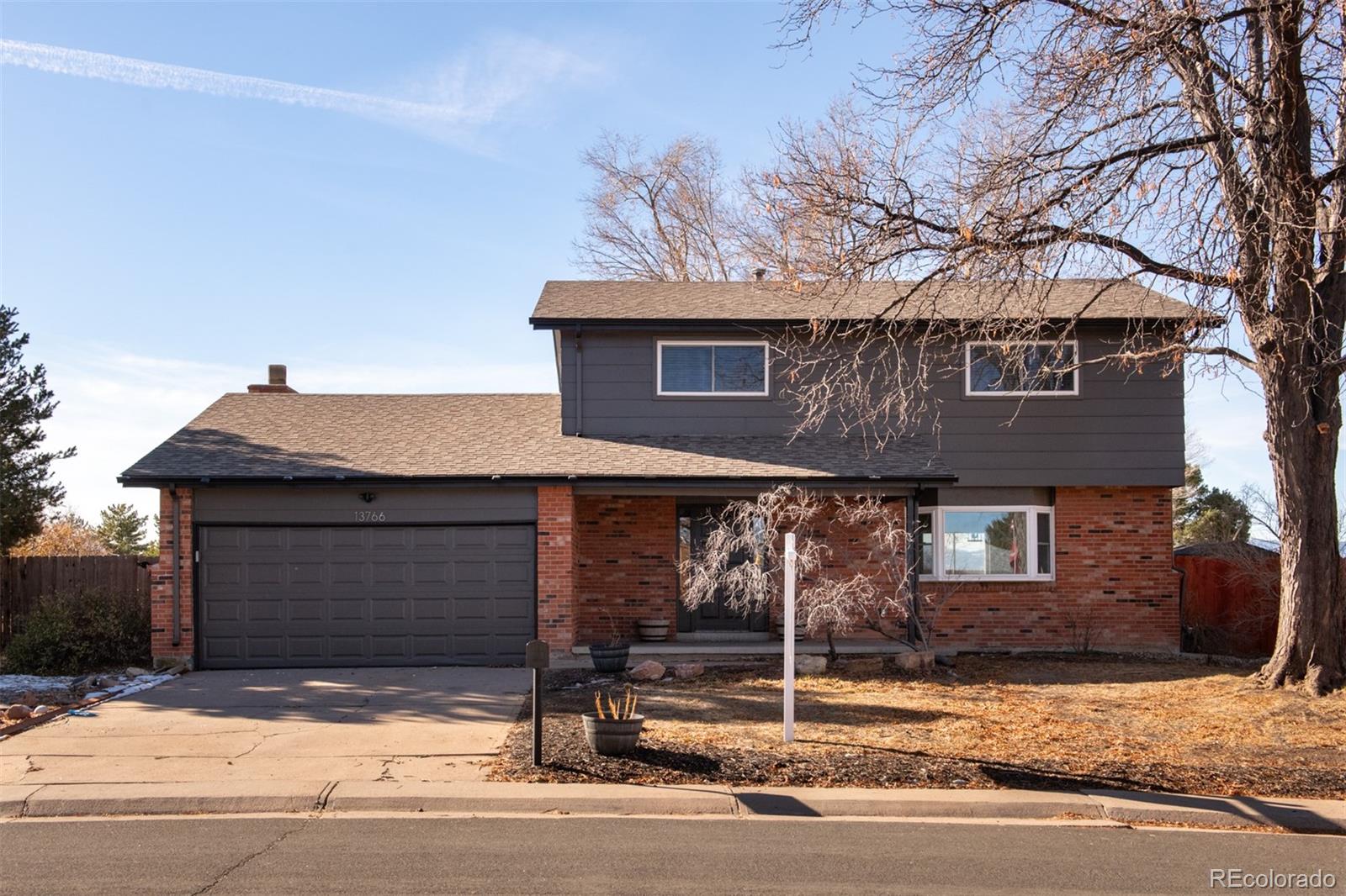 13766 Omega Circle Lone Tree, CO 80124 - Photo 1 of 37 a front view of a house with garage