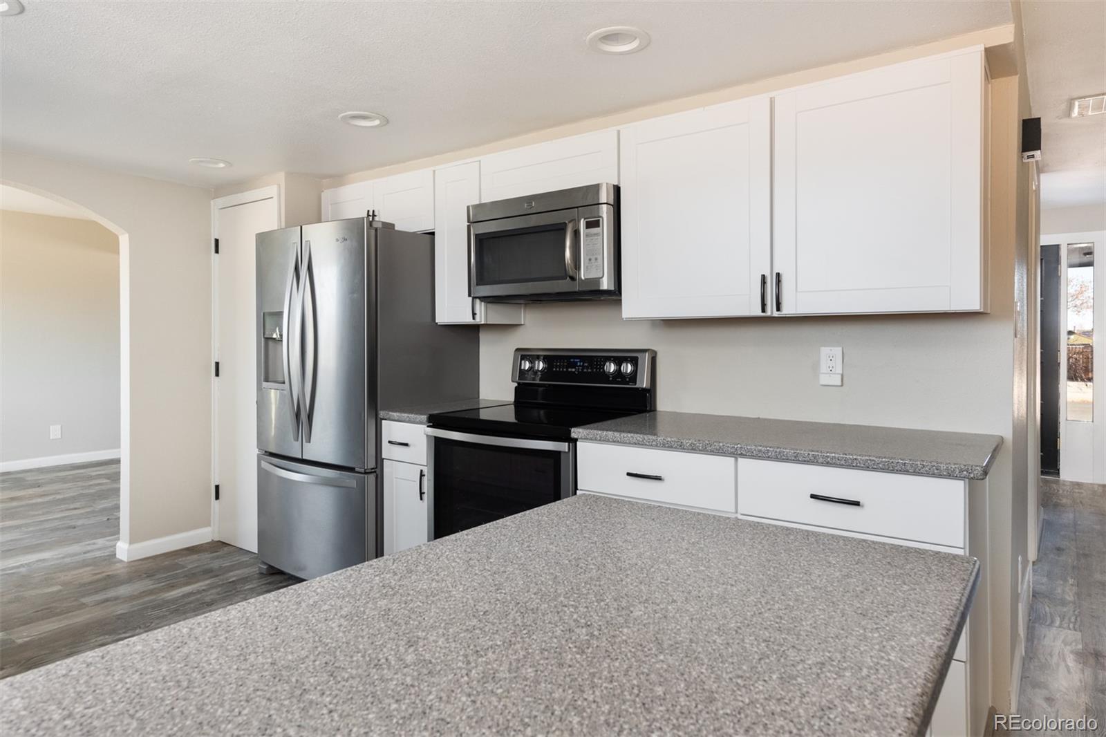 13766 Omega Circle Lone Tree, CO 80124 - Photo 12 of 37 a kitchen with stainless steel appliances a refrigerator sink and microwave