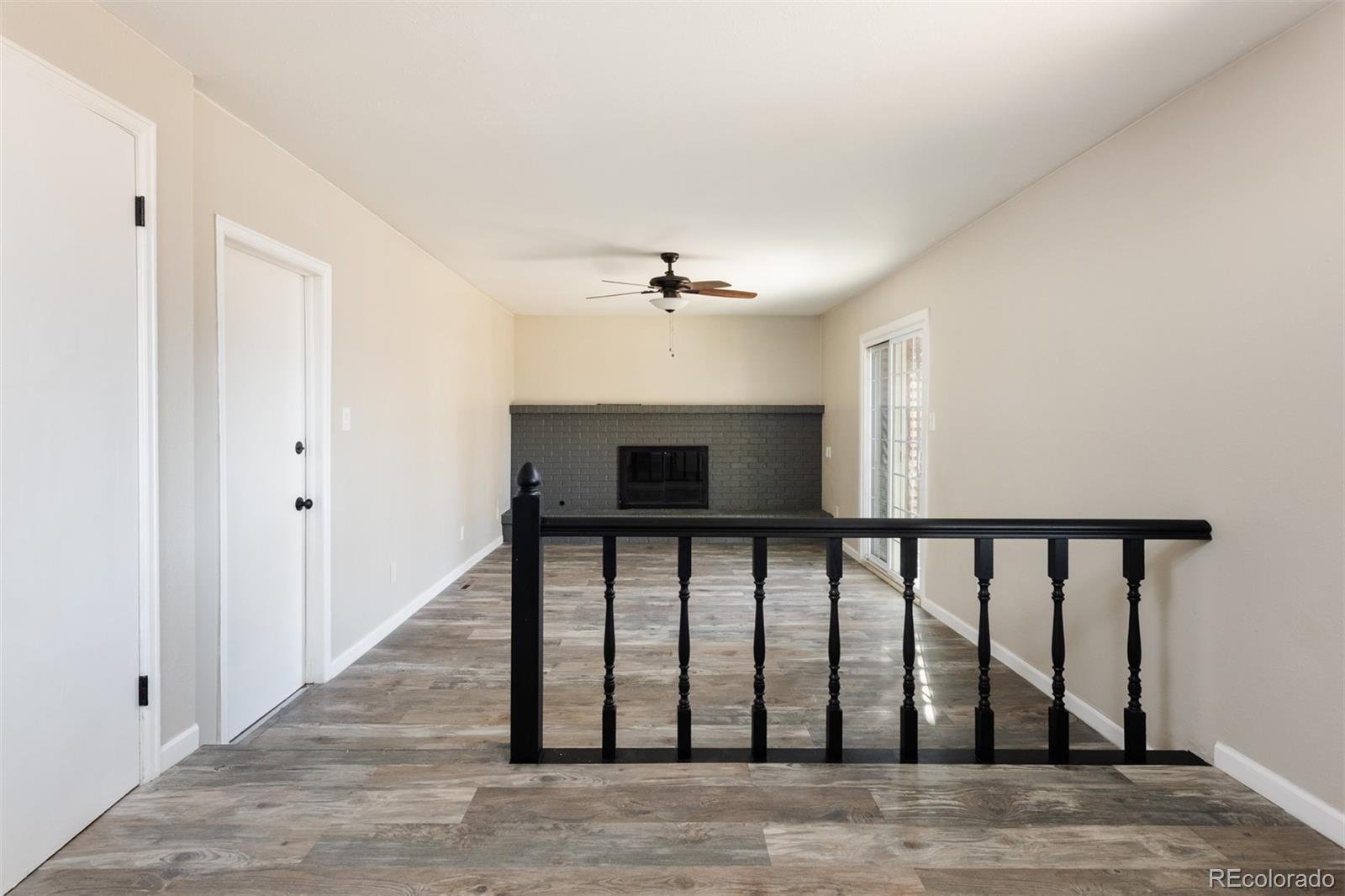 13766 Omega Circle Lone Tree, CO 80124 - Photo 14 of 37 a view of a hallway with wooden floor and staircase