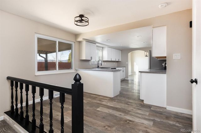 a kitchen with a refrigerator and a stove top oven