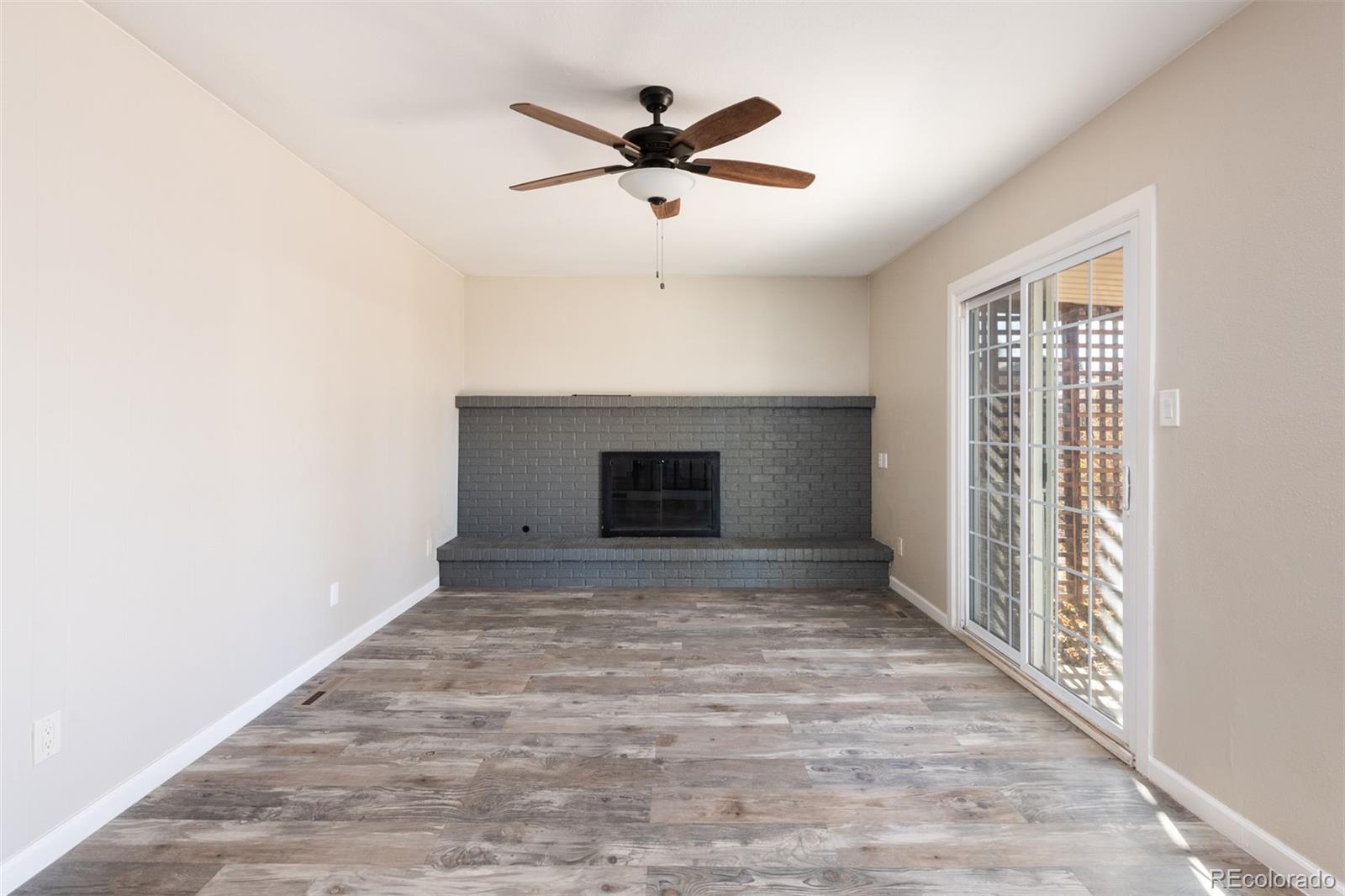 13766 Omega Circle Lone Tree, CO 80124 - Photo 16 of 37 a view of empty room with wooden floor and ceiling fan