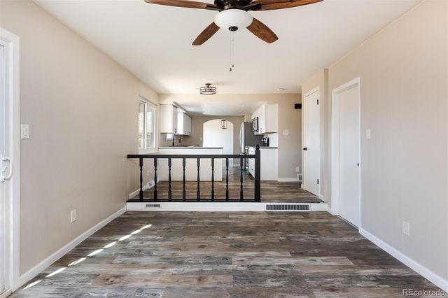 a view of entryway with stairs and a chandelier fan
