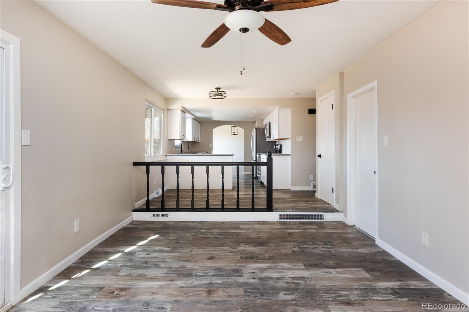13766 Omega Circle Lone Tree, CO 80124 - Photo 17 of 37 a view of entryway with stairs and a chandelier fan