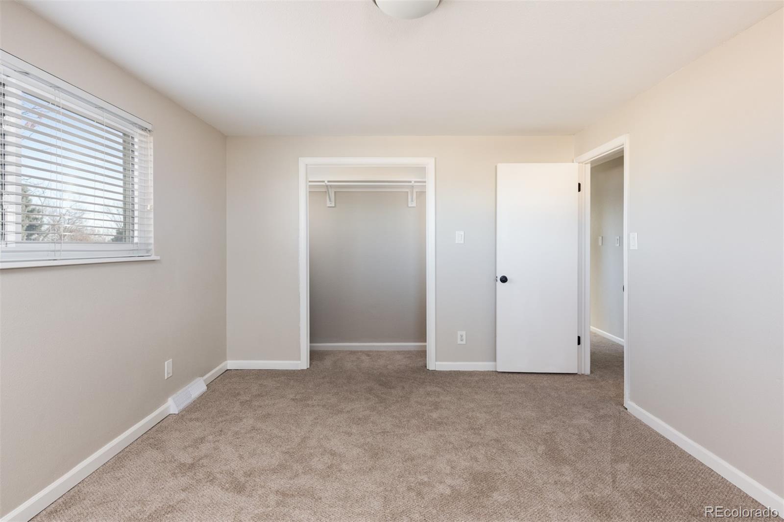 13766 Omega Circle Lone Tree, CO 80124 - Photo 23 of 37 an empty room with windows and closet