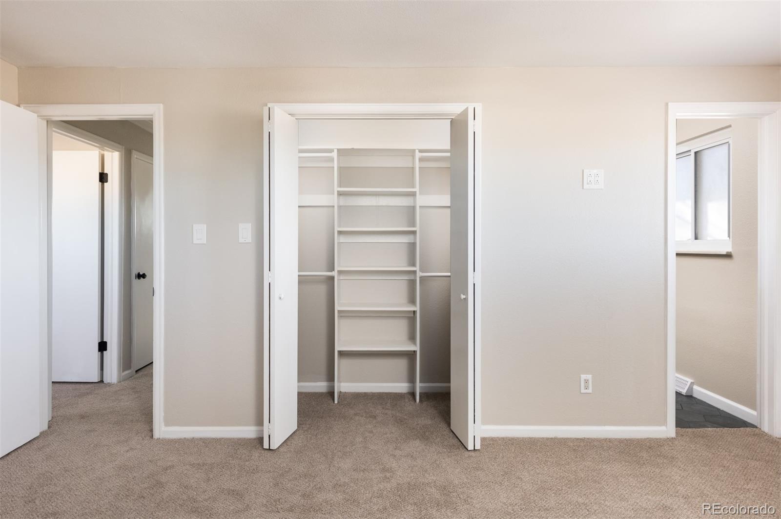 13766 Omega Circle Lone Tree, CO 80124 - Photo 24 of 37 a view of an empty room with closet and a window