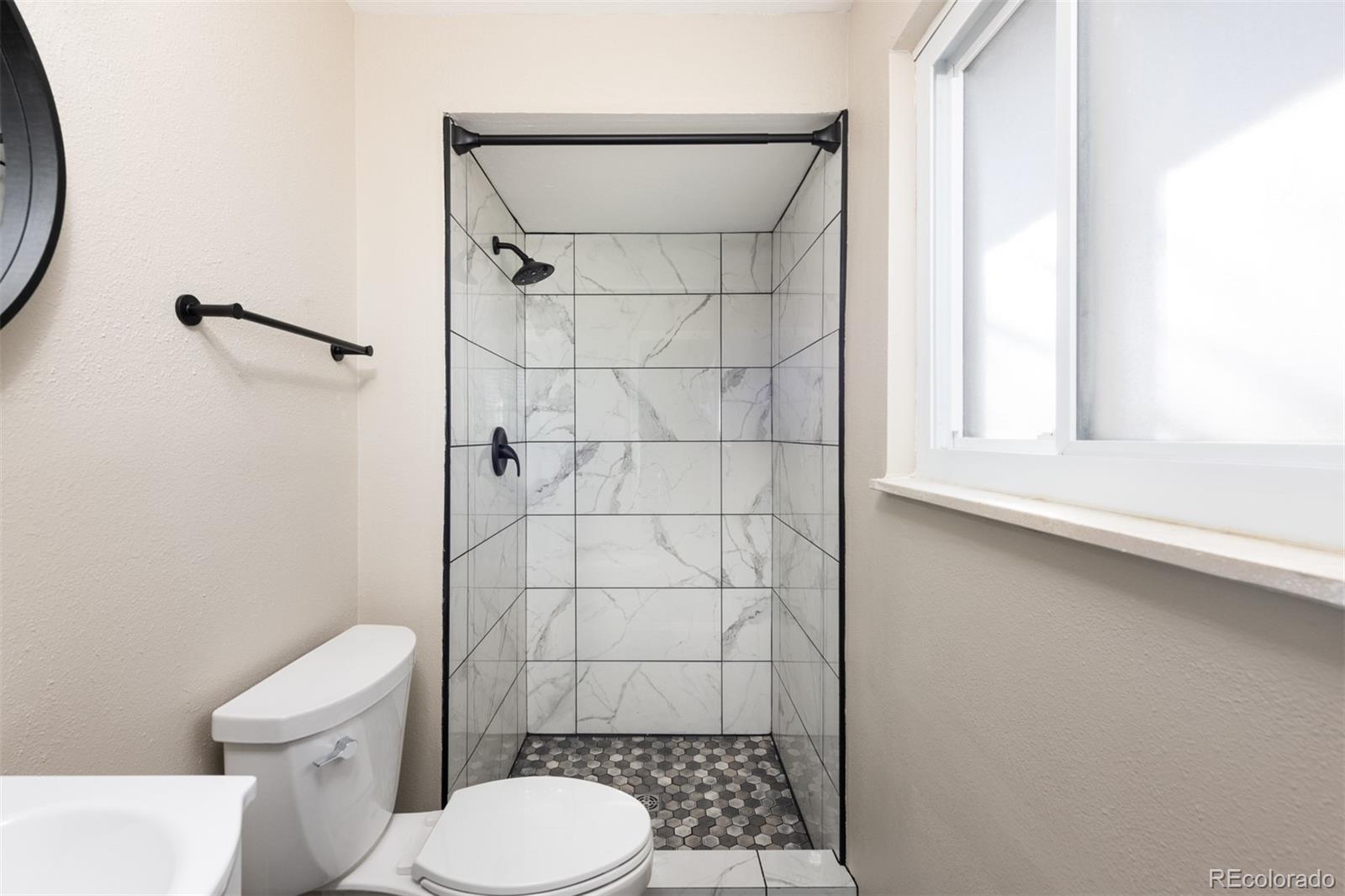 13766 Omega Circle Lone Tree, CO 80124 - Photo 26 of 37 a white toilet sitting next to a bathroom sink