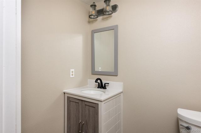 a bathroom with a sink a mirror and vanity