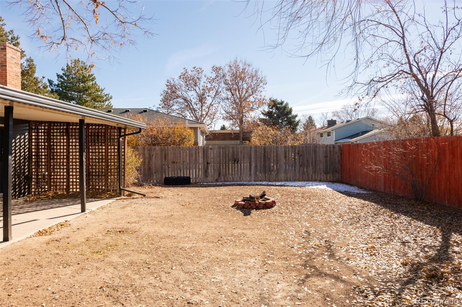 13766 Omega Circle Lone Tree, CO 80124 - Photo 34 of 37 a view of backyard with wooden fence and large trees