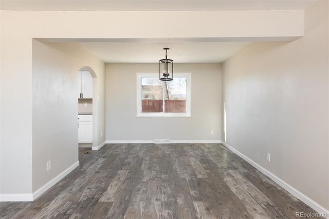 an empty room that has a window in it