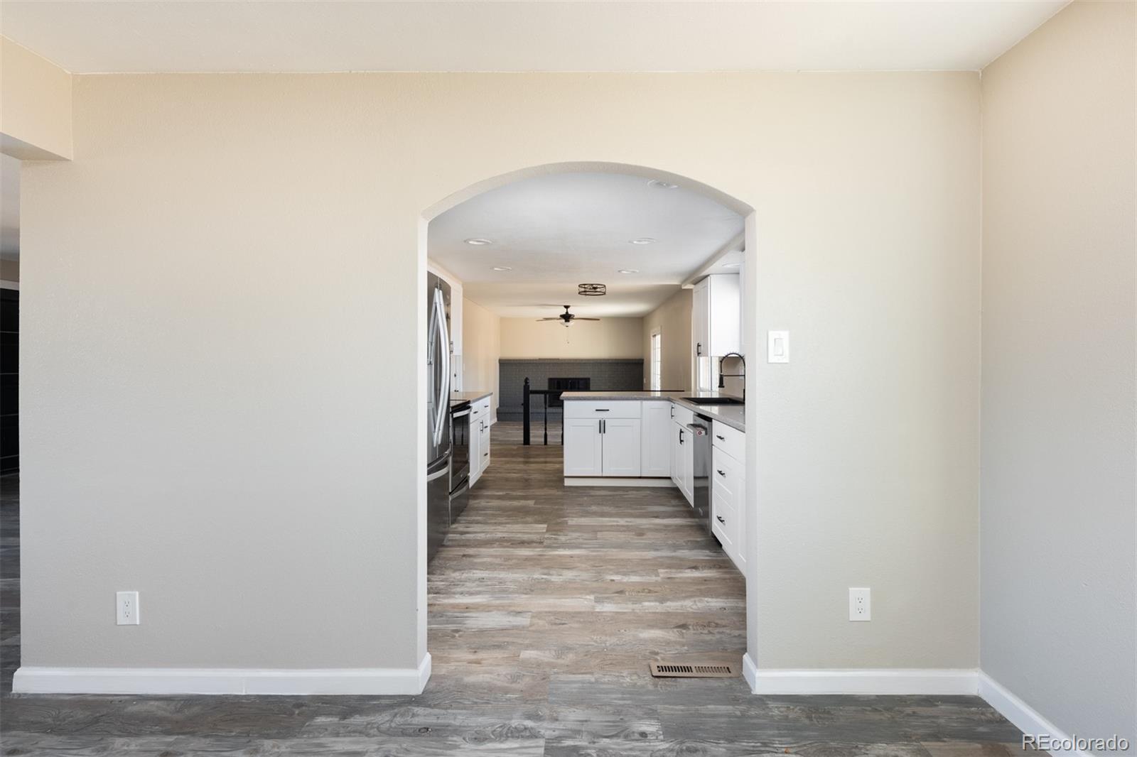 13766 Omega Circle Lone Tree, CO 80124 - Photo 9 of 37 a view of a living room with a fireplace and a ceiling fan