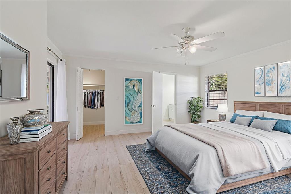 7337 Cambridge Way Clearwater, FL 33764 - Photo 11 of 28 a bedroom with a bed and wooden floor